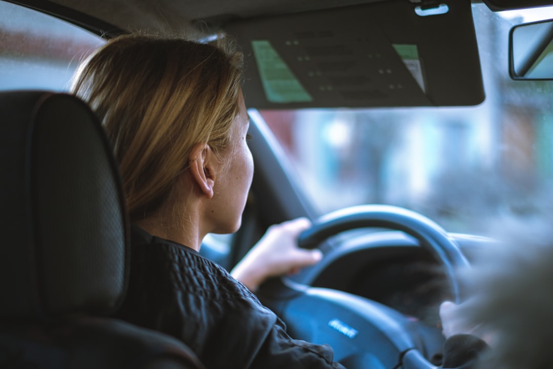 Cheap car insurance young drivers - woman driving car road